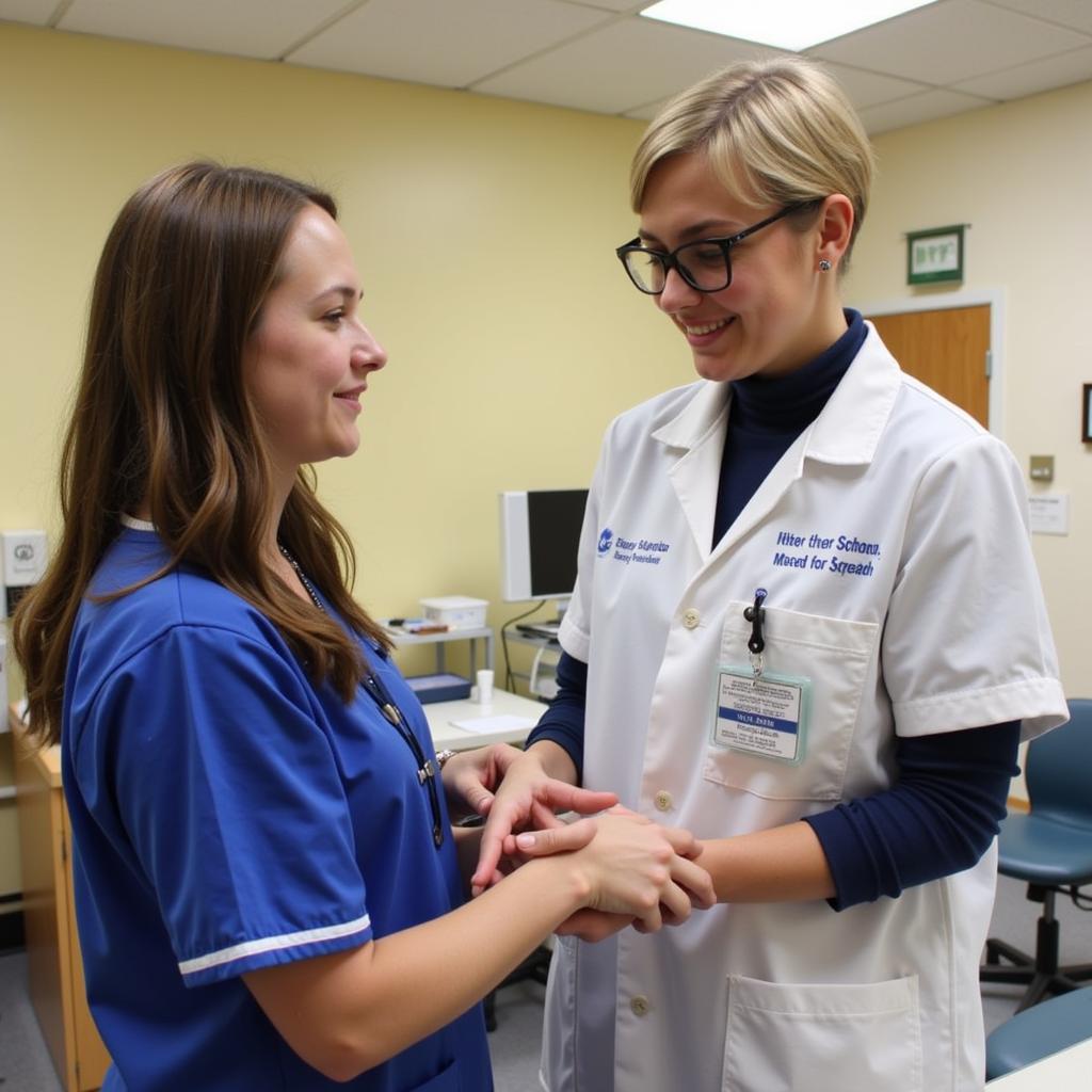 High school intern assisting a nurse with patient care.