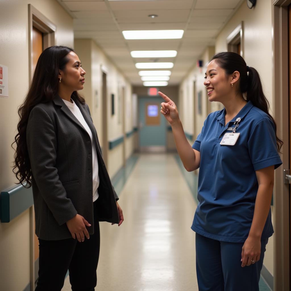 A hospital volunteer assisting a visitor with directions