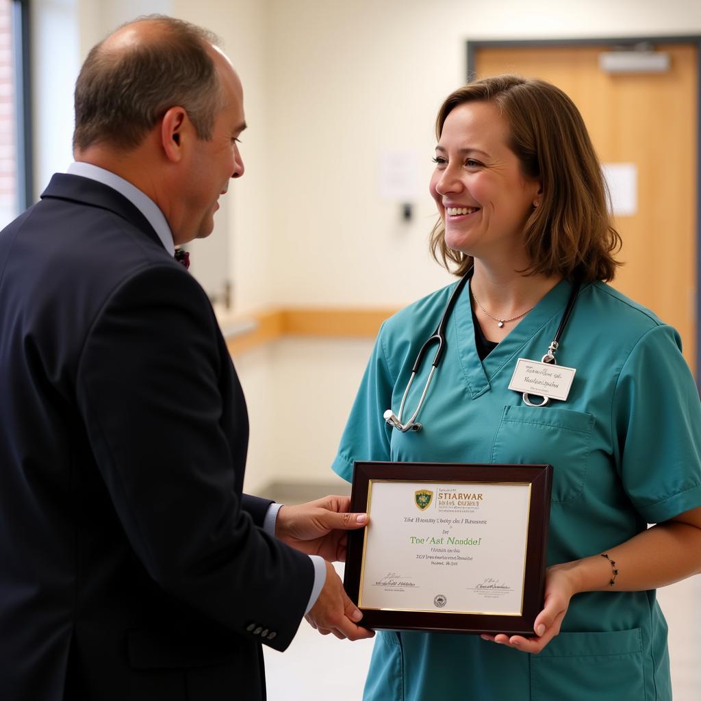 A hospital employee receiving an award for excellence