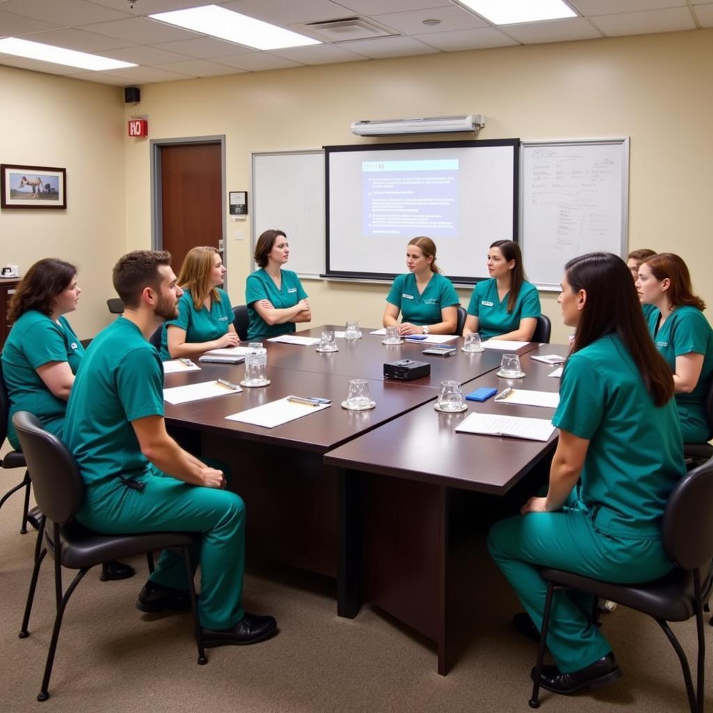 Equine hospital staff meeting in a conference room.