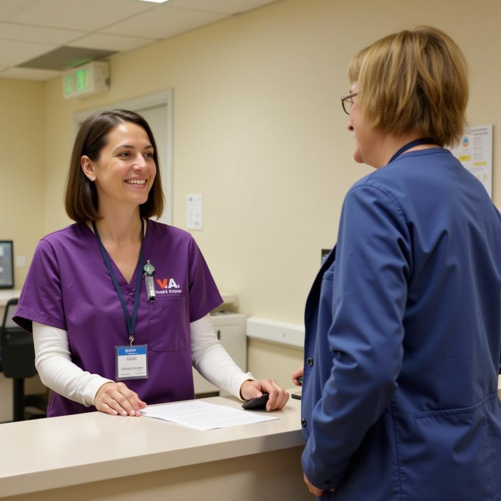 Halifax County Hospital VA Information Desk: A friendly staff member assisting a visitor at the information desk.