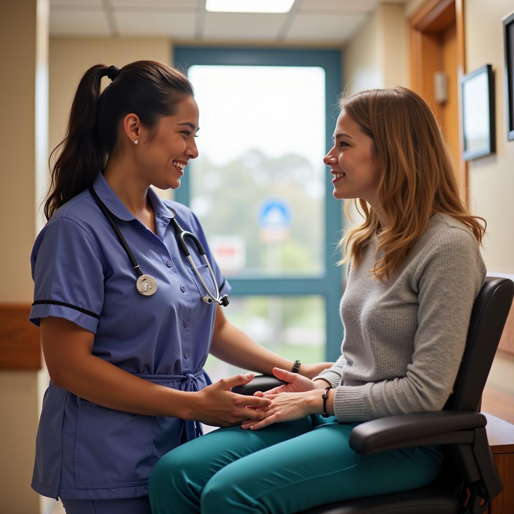 A hospitality aide talks with a patient